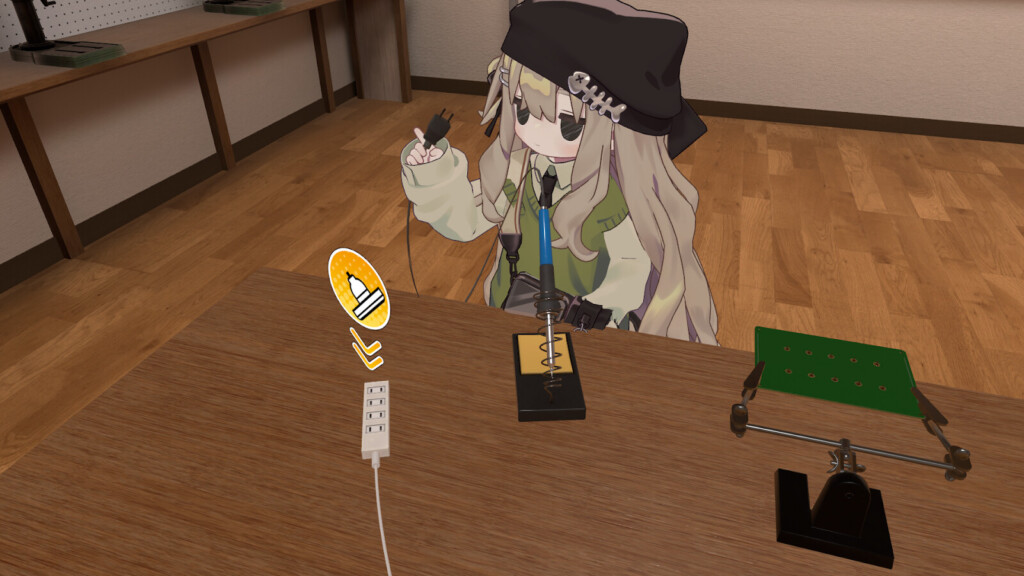 はんだごてのコンセントを持つ筆者